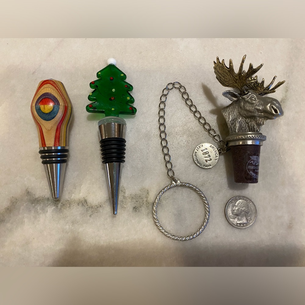 Set of 3 wine bottle stoppers. 1 wood, 1 glass, 1 metal.